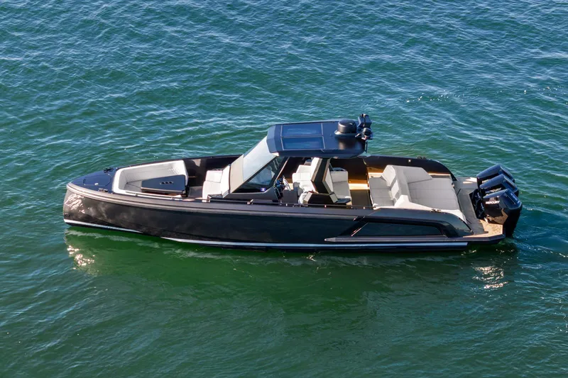 Slide: The Image of 2024 Vanquish Yachts 40 luxury boat cruising on open water. - 25