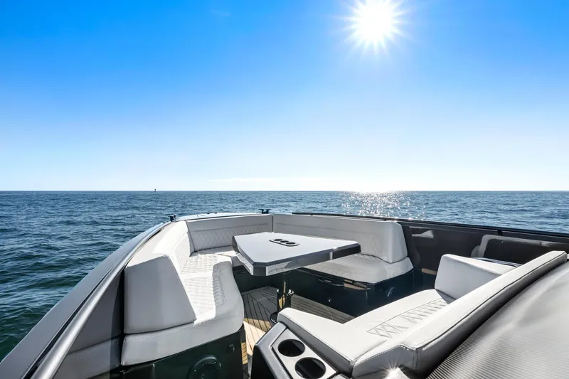Slide: The Image of 2024 Vanquish Yachts 40, luxurious seating area on open water under clear blue sky. - 34