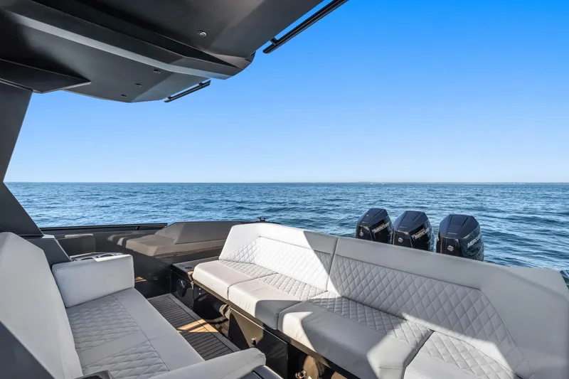 Slide: The Image of Luxurious 2024 Vanquish Yachts 40 with elegant seating, ocean view, and powerful engines. - 38