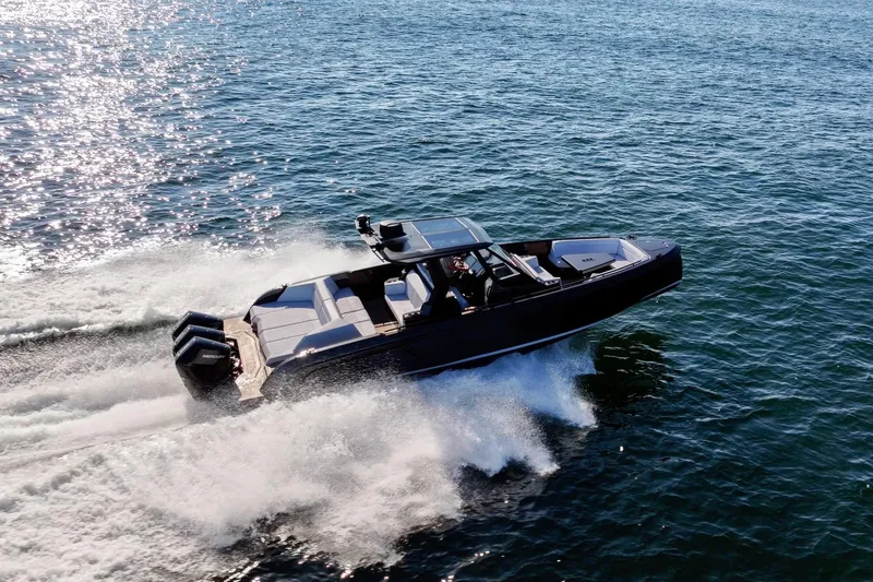 Slide: The Image of 2024 Vanquish Yachts 40 speeding on open water, showcasing sleek design and powerful engines. - 4