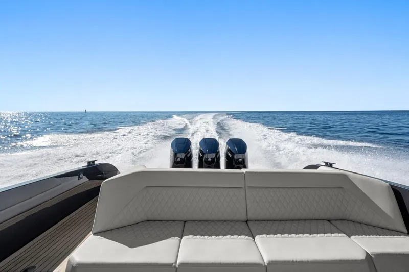 Slide: The Image of 2024 Vanquish Yachts 40 cruising on open water, showcasing powerful engines and sleek design. - 42