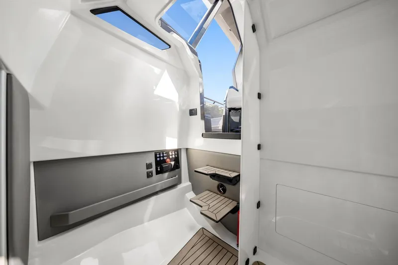 Slide: The Image of 2024 Vanquish Yachts 40 interior cabin with modern design and wooden steps. - 47