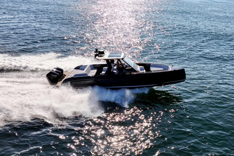 Slide: The Image of 2024 Vanquish Yachts 40 speeding on open water, reflecting sunlight. - 5