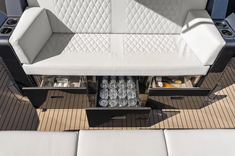 Slide: The Image of Luxurious seating with storage on 2024 Vanquish Yachts 40, featuring drinks and accessories. - 58