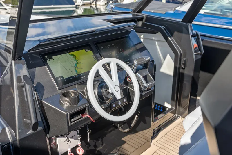 Slide: The Image of 2024 Vanquish Yachts 40 helm with modern navigation displays and sleek steering wheel. - 59