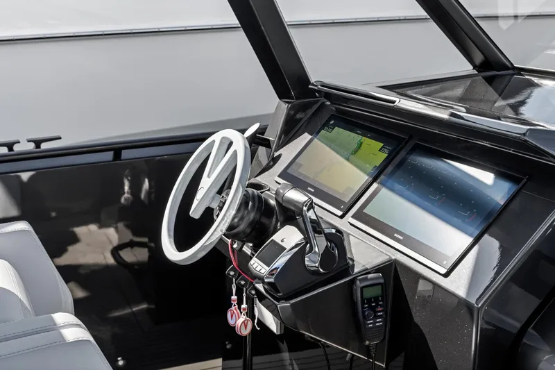 Slide: The Image of 2024 Vanquish Yachts 40 helm with modern controls and dual navigation screens. - 61