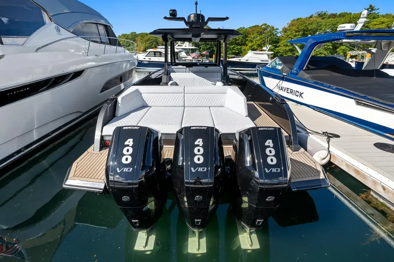Slide: The Image of 2024 Vanquish Yachts 40 with triple Mercury 400 V10 engines docked at marina. - 65
