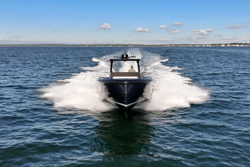 Slide: The Image of 2024 Vanquish Yachts 40 cruising on open water under a clear blue sky. - 9