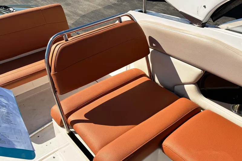 Slide: The Image of 2011 Regal 2565 Express Cruiser interior with orange seating and stainless steel frame. - 3