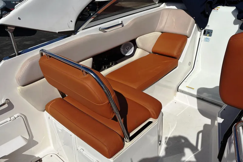 Slide: The Image of 2011 Regal 2565 Express Cruiser interior with tan leather seating and white accents. - 4