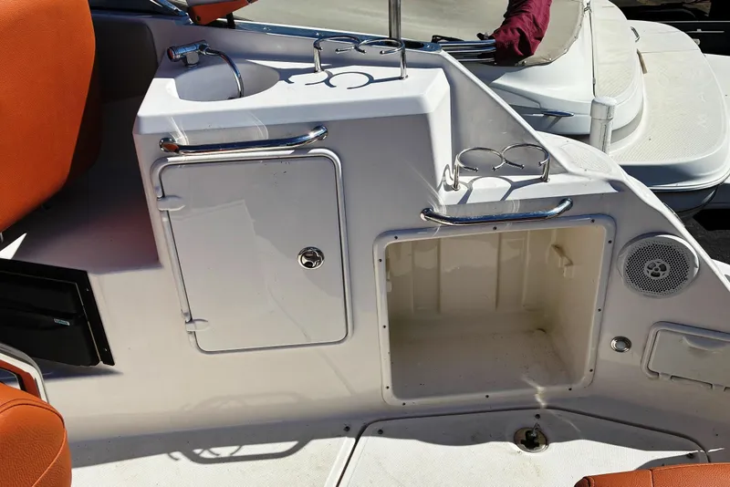 Slide: The Image of 2011 Regal 2565 Express Cruiser interior with sink, storage, and cup holders. - 6
