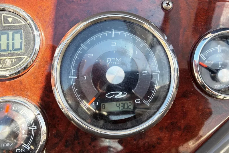 Slide: The Image of Dashboard of 2011 Regal 2565 Express Cruiser showing RPM and temperature gauges. - 9