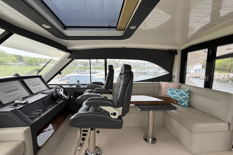 Slide: The Image of Luxurious interior of 2017 Maritimo M54 yacht with helm, seating, and Garmin navigation. - 11