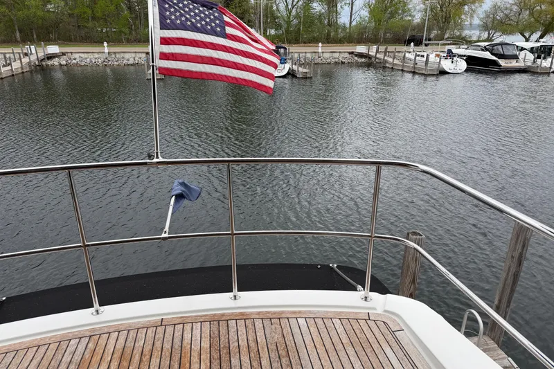 Slide: The Image of 2017 Maritimo M54 yacht with American flag docked at marina. - 17