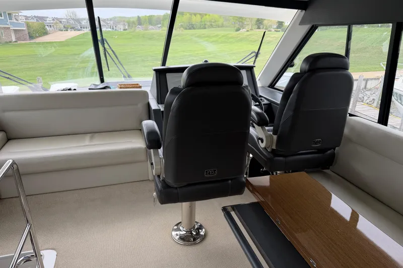 Slide: The Image of Interior of 2017 Maritimo M54 yacht with helm chairs and panoramic windows. - 18