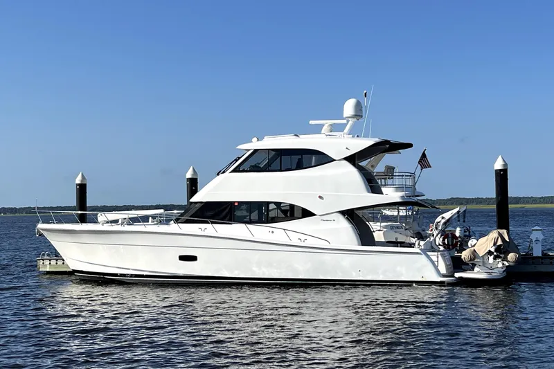 The Image of 2017 Maritimo M54 yacht docked on calm water under clear blue sky. - 2
