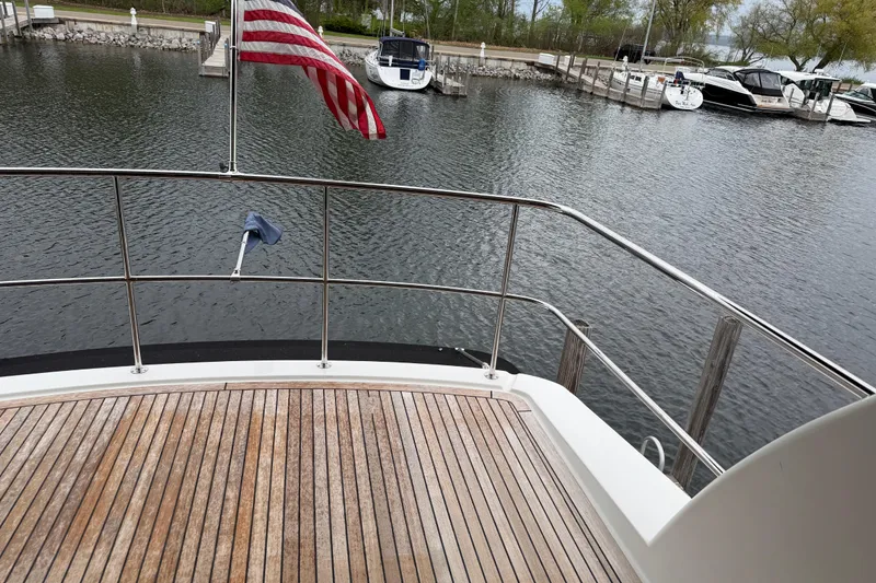 Slide: The Image of 2017 Maritimo M54 yacht deck with American flag, docked in a marina. - 20