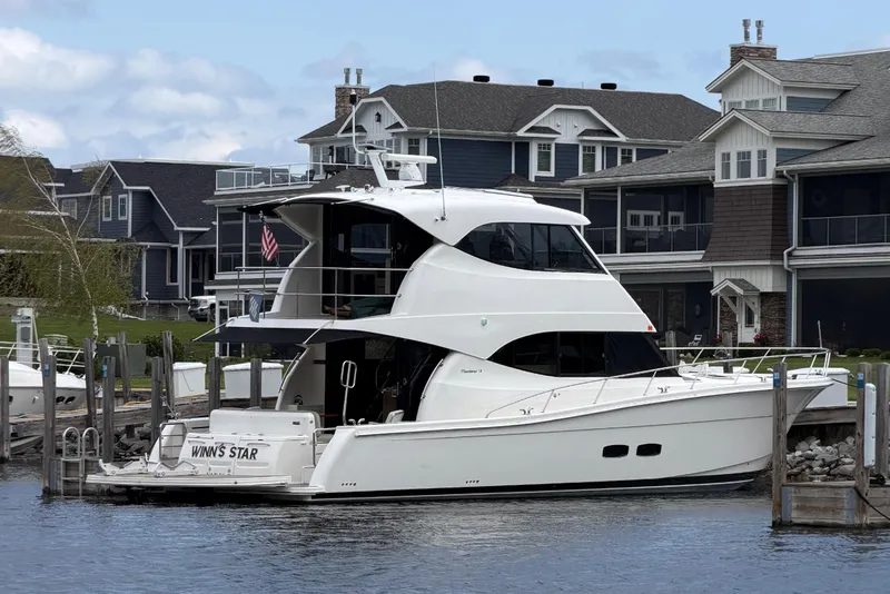 Slide: The Image of 2017 Maritimo M54 yacht docked near modern houses. - 21