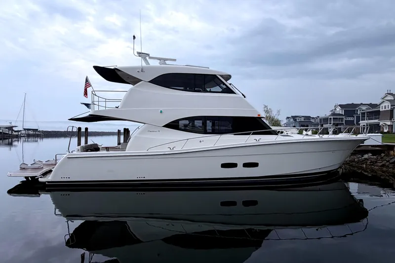 Slide: The Image of 2017 Maritimo M54 yacht docked on calm water under clear blue sky. - 3