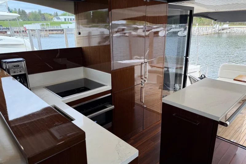 Slide: The Image of Luxurious 2017 Maritimo M54 yacht kitchen with modern appliances and sleek wood cabinetry. - 7