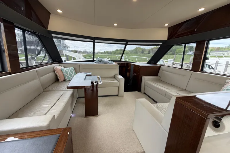 Slide: The Image of Luxurious interior of 2017 Maritimo M54 yacht with plush seating and panoramic windows. - 9