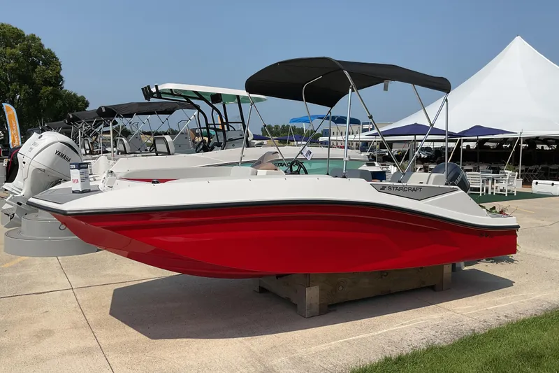 The Image of 2026 Starcraft SV 16 OB boat with red hull displayed outdoors. - 0