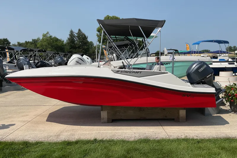 Slide: The Image of 2026 Starcraft SV 16 OB boat with red hull and Yamaha outboard motor. - 2