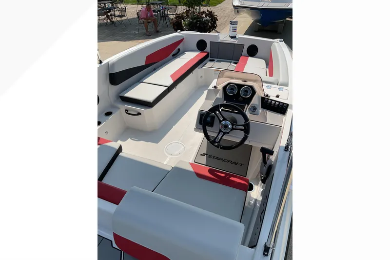 Slide: The Image of 2026 Starcraft SV 16 OB boat interior with modern seating and steering console. - 9