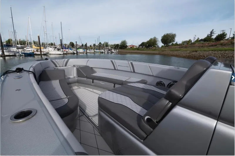 Slide: The Image of 2020 Midnight Express 37 Open boat interior with sleek seating at a marina. - 2