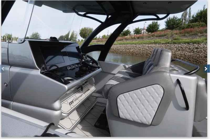 Slide: The Image of Interior view of 2020 Midnight Express 37 Open boat, featuring sleek dashboard and seating. - 3