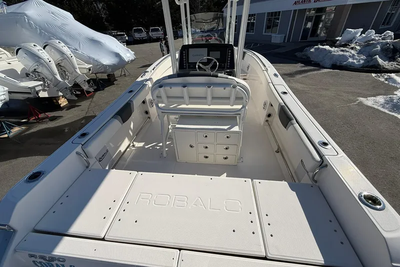 Slide: The Image of 2022 Robalo R230 Center Console boat interior with helm and storage compartments. - 22