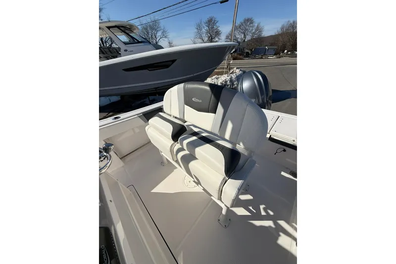 Slide: The Image of 2022 Robalo R230 Center Console boat interior with cushioned seating. - 26