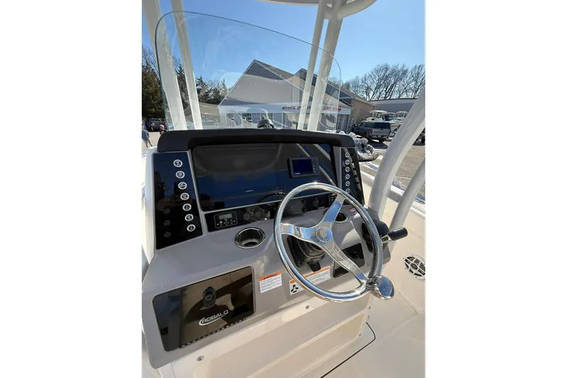 Slide: The Image of 2022 Robalo R230 Center Console boat dashboard with steering wheel and controls. - 29