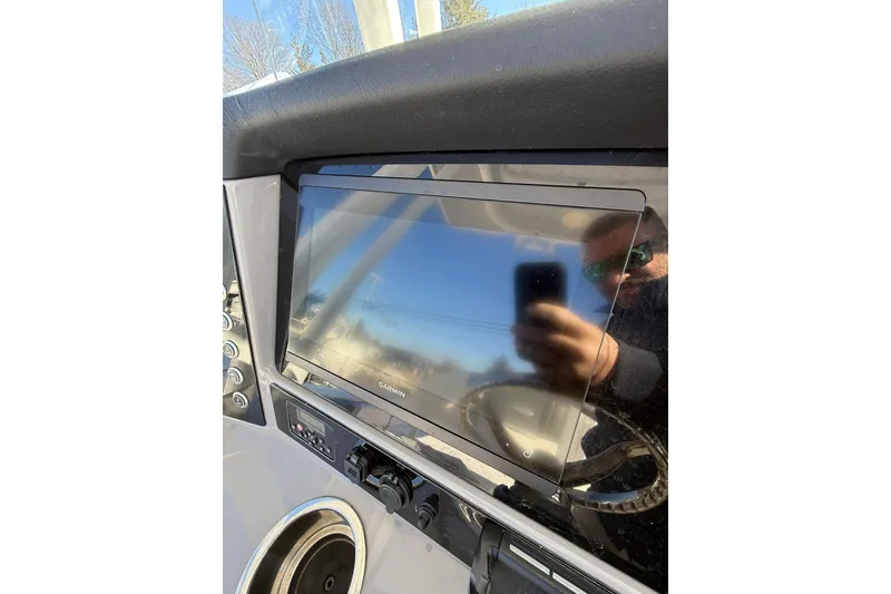 Slide: The Image of 2022 Robalo R230 Center Console dashboard with Garmin display and steering wheel reflection. - 31