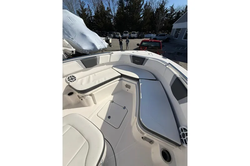 Slide: The Image of 2022 Robalo R230 Center Console boat interior with cushioned seating and storage compartments. - 35