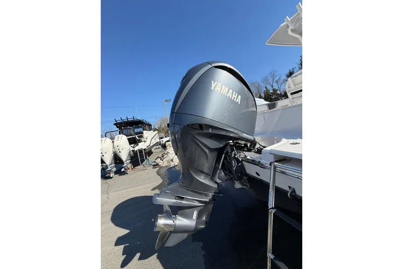 Slide: The Image of 2022 Robalo R230 Center Console with Yamaha outboard motor, parked outdoors. - 44