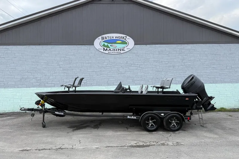 The Image of 2026 SeaArk Flex 21 Pro boat on trailer, parked outside Water Workz Marine. - 1