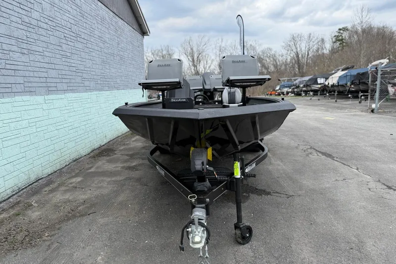 Slide: The Image of 2026 SeaArk Flex 21 Pro boat on trailer, parked outdoors near a building. - 3