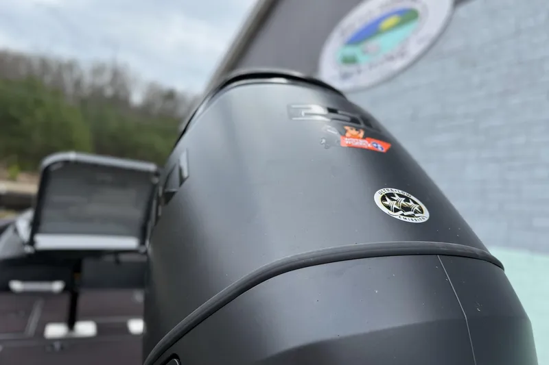 Slide: The Image of Close-up of a 2026 SeaArk Flex 21 Pro boat engine with logo and stickers. - 5