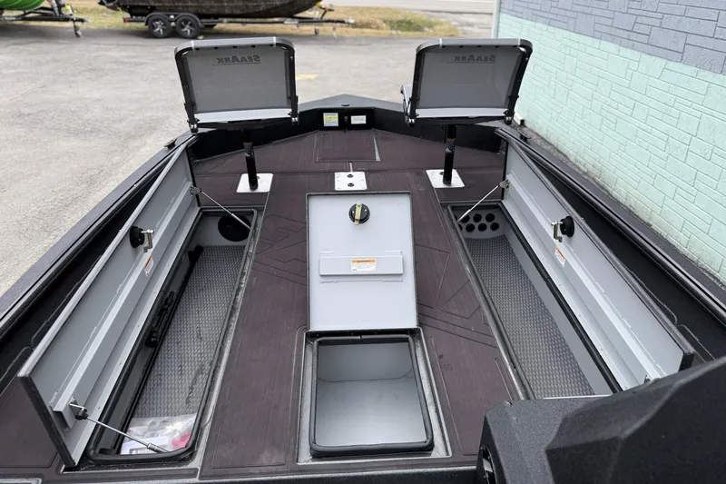 Slide: The Image of 2026 SeaArk Flex 21 Pro boat interior with open storage compartments and sleek design. - 8