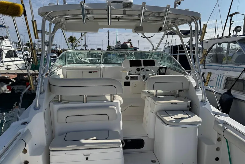 Slide: The Image of 2007 Wellcraft 290 Coastal boat interior with helm and seating at marina. - 11