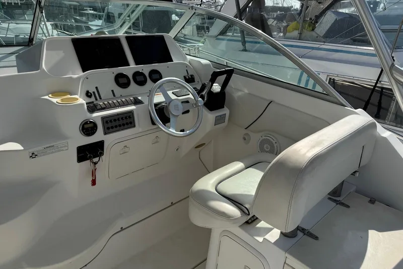 Slide: The Image of 2007 Wellcraft 290 Coastal boat cockpit with steering wheel and control panel. - 14