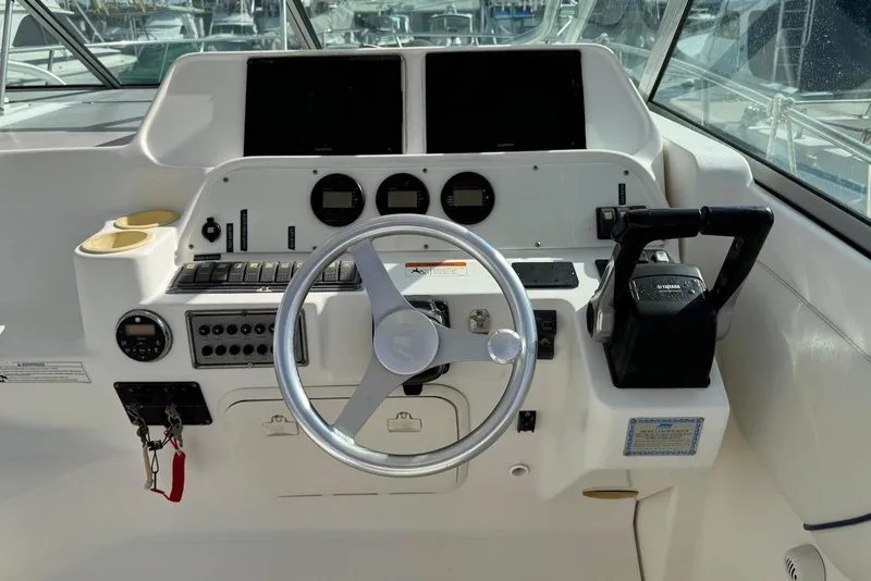 Slide: The Image of 2007 Wellcraft 290 Coastal helm with steering wheel, controls, and instrument panel. - 15