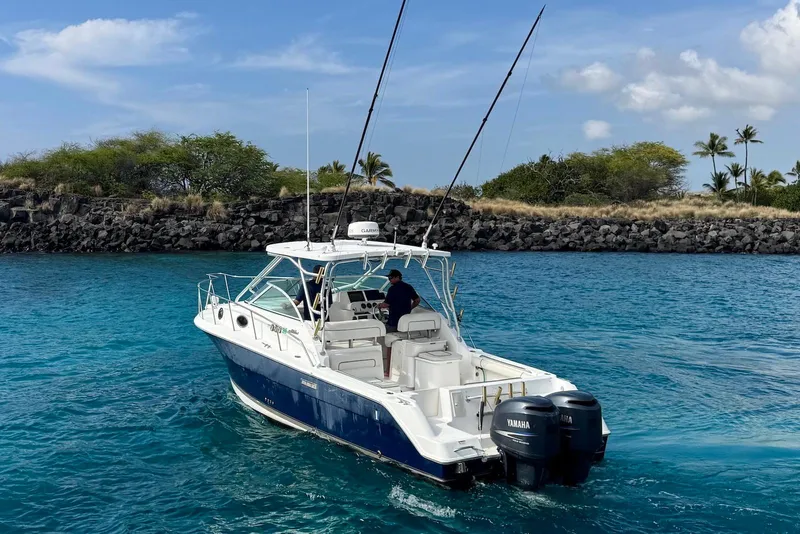 Slide: The Image of 2007 Wellcraft 290 Coastal boat on clear blue water near rocky shoreline. - 4
