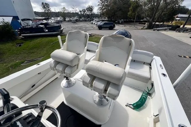 Slide: The Image of 2016 Parker 21SE Center Console boat with dual white captain chairs and steering wheel. - 11