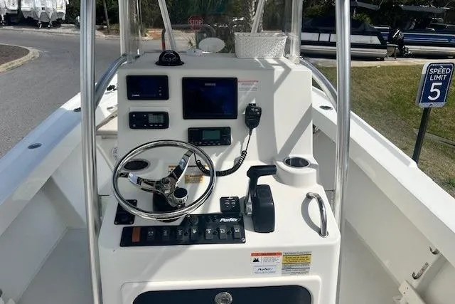 Slide: The Image of 2016 Parker 21SE Center Console boat interior with steering wheel and navigation equipment. - 14