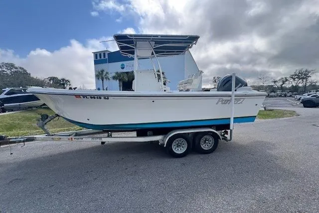 Slide: The Image of 2016 Parker 21SE Center Console boat on trailer, parked outdoors under cloudy sky. - 3