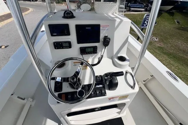 Slide: The Image of 2016 Parker 21SE Center Console boat dashboard with steering wheel and navigation controls. - 4