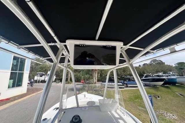Slide: The Image of 2016 Parker 21SE Center Console boat with T-top and electronics, docked outdoors. - 5
