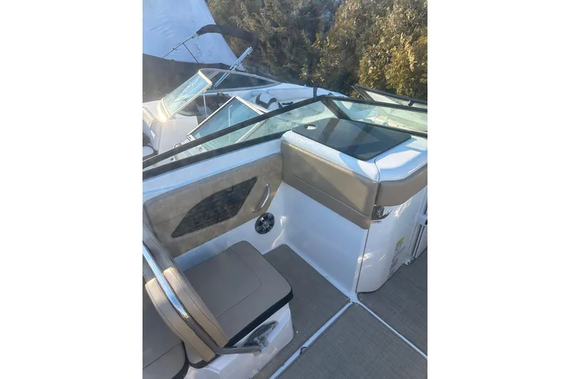 Slide: The Image of 2023 Sea Ray SPX 230 Outboard interior with beige seating and sleek design. - 17